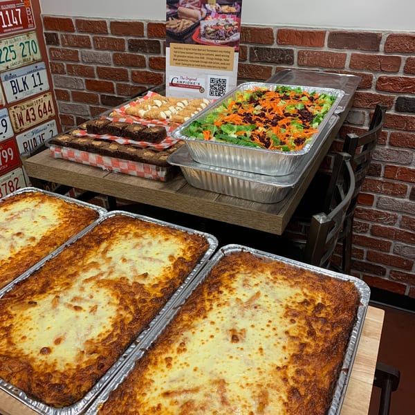 Catering trays of lasagna, salad, brownies, and cannolis from Campione's Taste of Chicago.