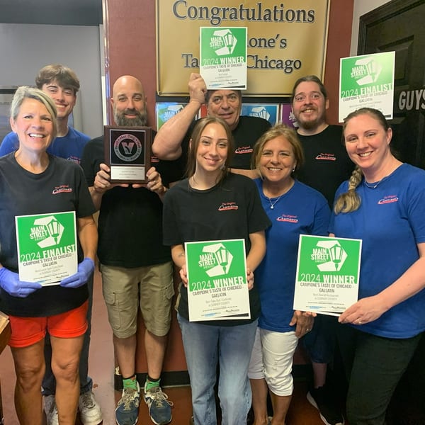 Nine smiling Campione's Taste of Chicago staff members proudly display their 2024 Main Street Awards.